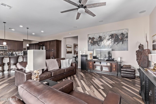 living area with visible vents, a ceiling fan, recessed lighting, baseboards, and dark wood-style flooring