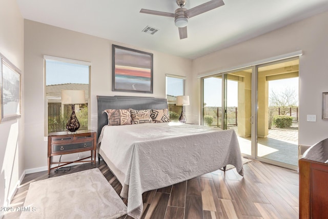 bedroom with access to exterior, visible vents, ceiling fan, baseboards, and wood finished floors