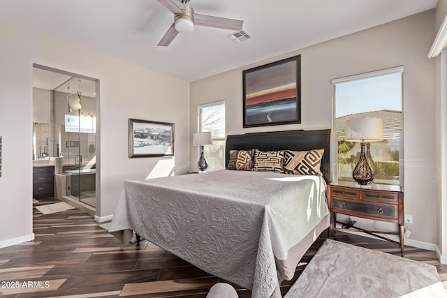 bedroom featuring dark wood-style floors, visible vents, baseboards, ceiling fan, and ensuite bathroom