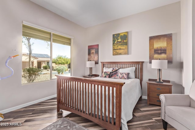 bedroom featuring access to outside, baseboards, and wood finished floors