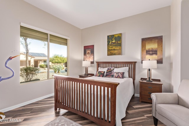 bedroom with access to exterior, baseboards, and wood finished floors