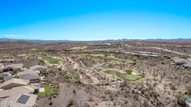 aerial view with view of golf course and a mountain view