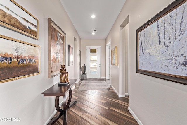 corridor with visible vents, recessed lighting, baseboards, and dark wood-style flooring