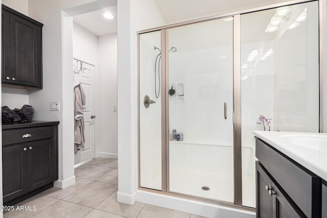 bathroom with vanity, an enclosed shower, and tile patterned flooring