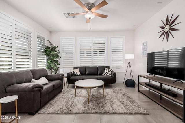 tiled living room featuring ceiling fan