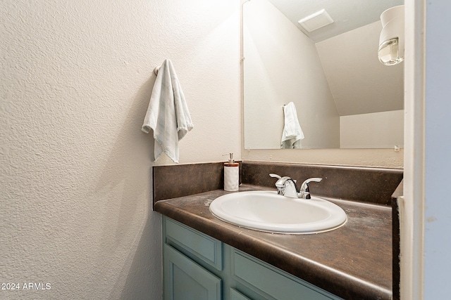 bathroom featuring vanity and vaulted ceiling