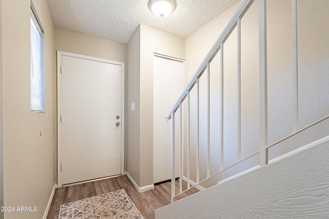 entrance foyer featuring light hardwood / wood-style flooring and a textured ceiling