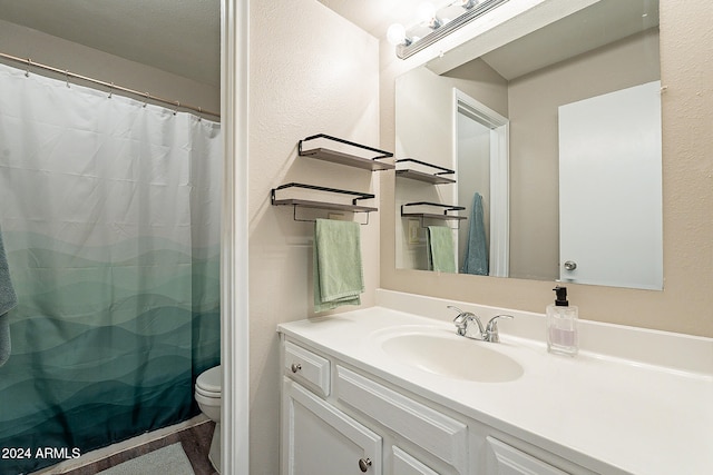 bathroom featuring vanity, a shower with curtain, and toilet