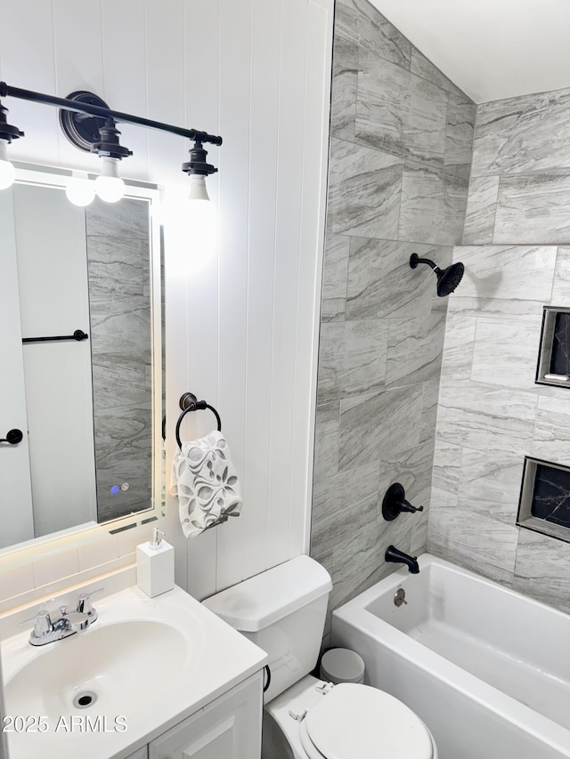 bathroom featuring vanity, toilet, and shower / washtub combination