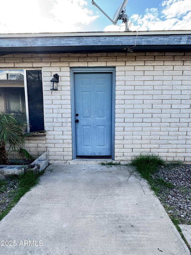 entrance to property with brick siding