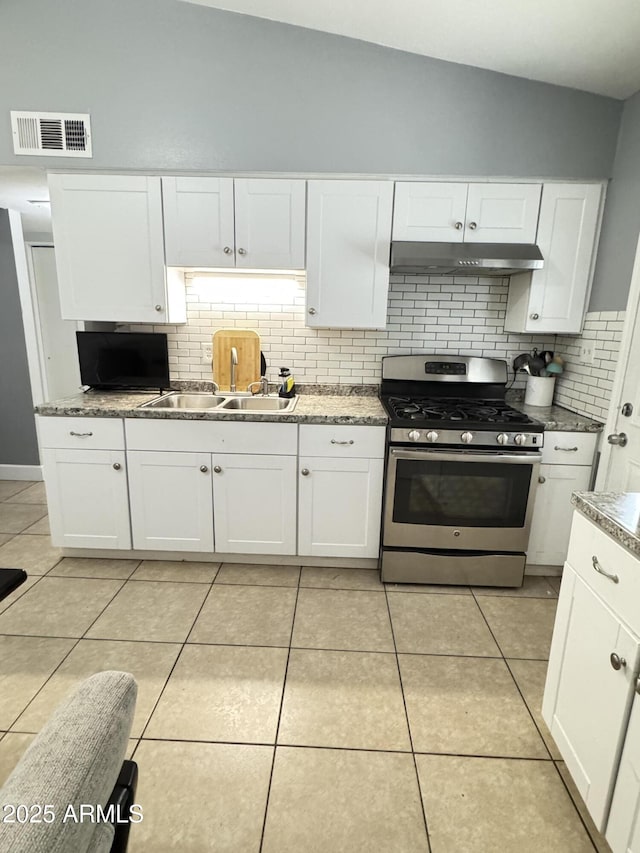 kitchen with visible vents, under cabinet range hood, a sink, light tile patterned floors, and stainless steel gas range