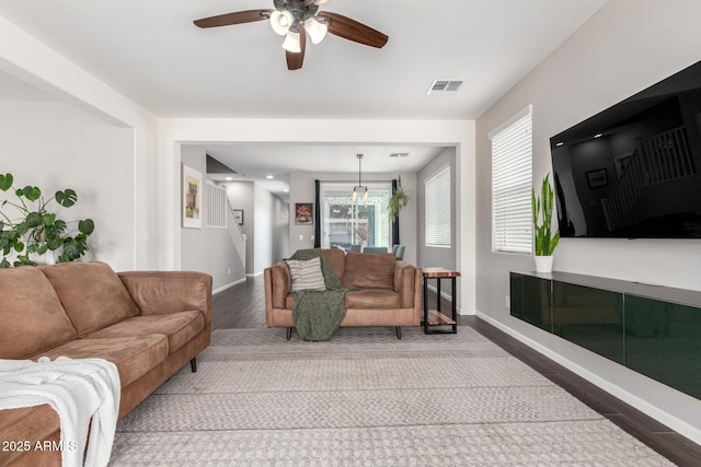 2562 N Springfield St, Buckeye, AZ 85396 - living area with a ceiling fan, baseboards, wood finished floors, and stairway