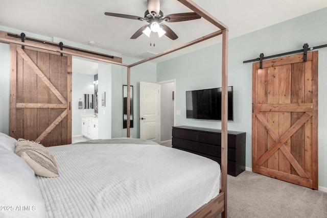 2562 N Springfield St, Buckeye, AZ 85396 - carpeted bedroom with a barn door, ensuite bath, baseboards, and a ceiling fan