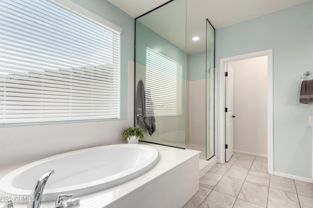 2562 N Springfield St, Buckeye, AZ 85396 - bathroom with a garden tub, a shower stall, and marble look tiles