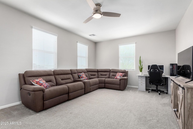 2562 N Springfield St, Buckeye, AZ 85396 - living area featuring light carpet, ceiling fan, a desk, and baseboards