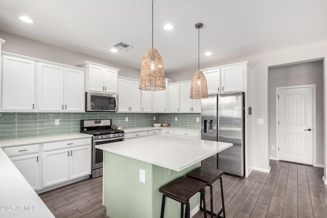 2562 N Springfield St, Buckeye, AZ 85396 - kitchen featuring appliances with stainless steel finishes, dark wood finished floors, white cabinetry, light countertops, and recessed lighting