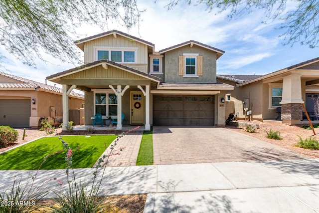 2562 N Springfield St, Buckeye, AZ 85396 - craftsman-style home featuring covered porch, stucco siding, decorative driveway, and an attached garage