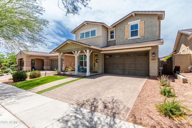 2562 N Springfield St, Buckeye, AZ 85396 - view of front of home with decorative driveway, a garage, stucco siding, and a porch