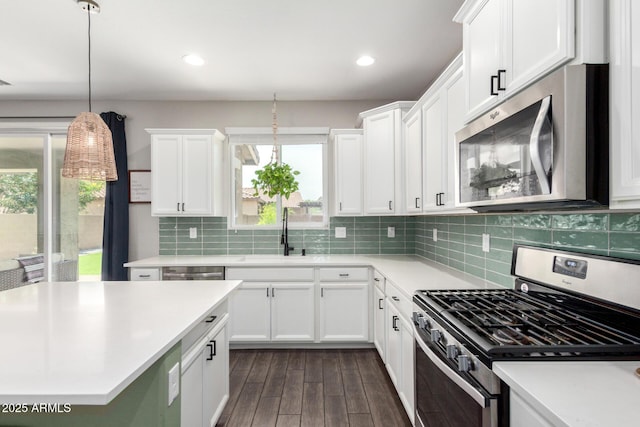 2562 N Springfield St, Buckeye, AZ 85396 - kitchen with appliances with stainless steel finishes, a sink, dark wood-style floors, light countertops, and white cabinets