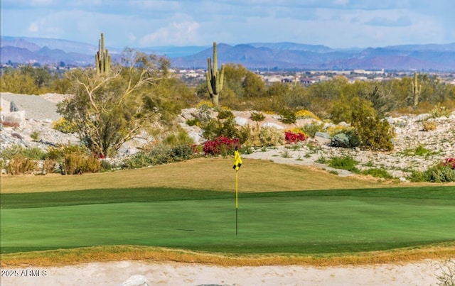 2562 N Springfield St, Buckeye, AZ 85396 - view of community with golf course view, a mountain view, an area to practice putting, and a lawn