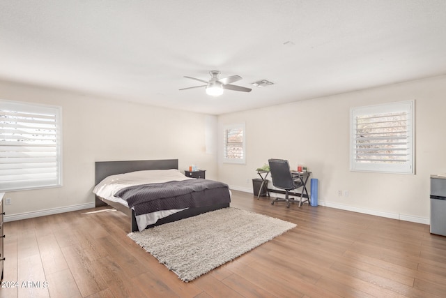 bedroom with hardwood / wood-style floors and ceiling fan