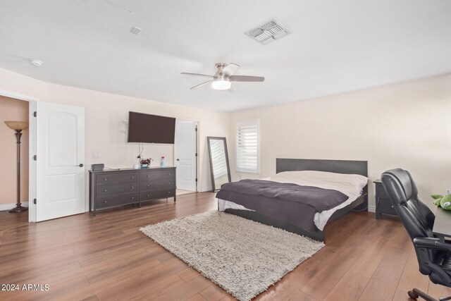 bedroom with ceiling fan and dark hardwood / wood-style floors