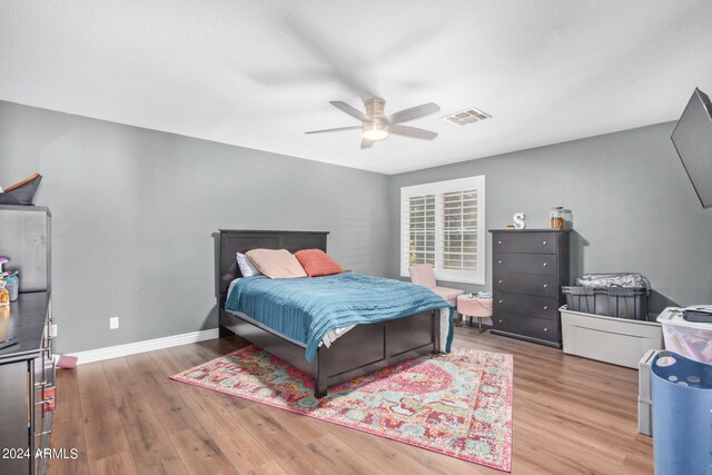 bedroom with ceiling fan and wood-type flooring