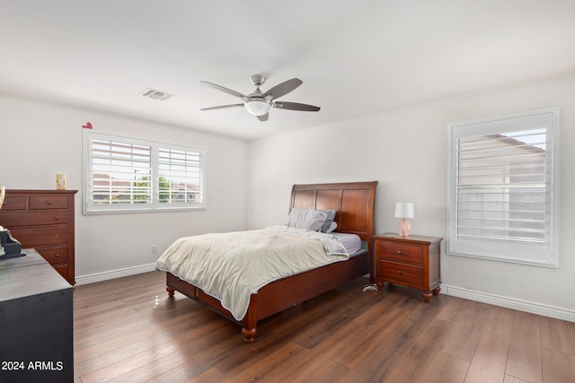 bedroom with ceiling fan and dark hardwood / wood-style floors