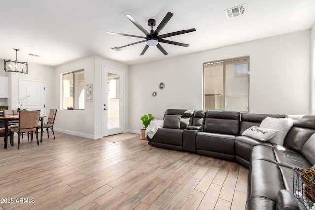 3875 E Claxton Ave, Gilbert, AZ 85297 - living room with a ceiling fan, a chandelier, light wood-style floors, and baseboards