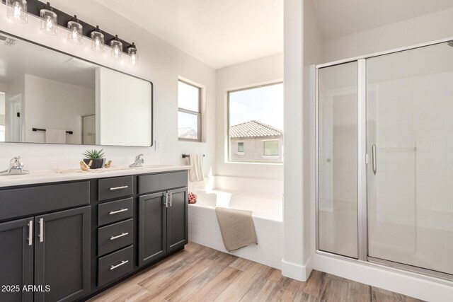 3875 E Claxton Ave, Gilbert, AZ 85297 - bathroom with a bath, a shower stall, double vanity, and wood finished floors