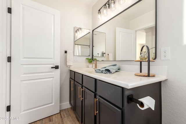 3875 E Claxton Ave, Gilbert, AZ 85297 - bathroom with vanity, wood finished floors, and baseboards