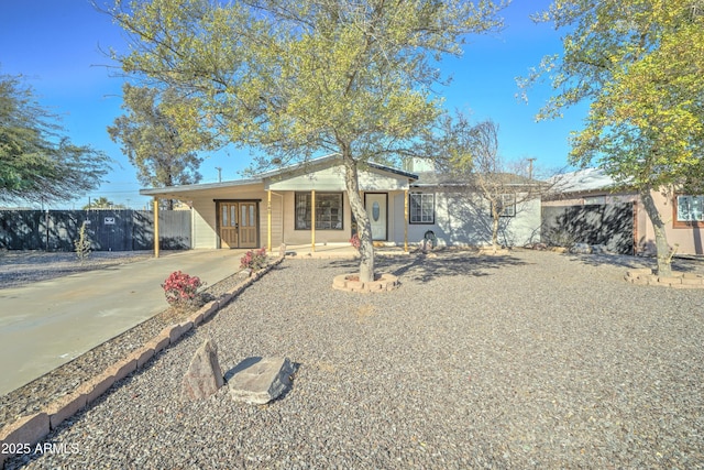 ranch-style house featuring a carport