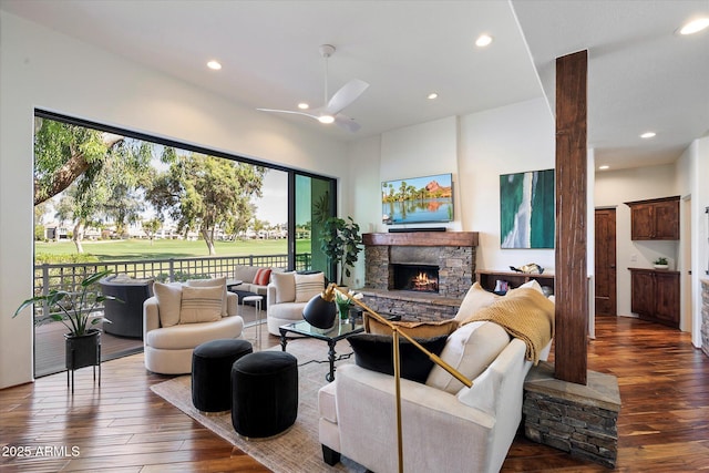7272 E Gainey Ranch Rd Unit 29, Scottsdale, AZ 85258 - living room with ceiling fan, dark wood-style flooring, recessed lighting, and a stone fireplace