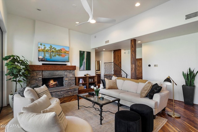7272 E Gainey Ranch Rd Unit 29, Scottsdale, AZ 85258 - living room featuring a ceiling fan, wood finished floors, a fireplace, stairway, and a high ceiling