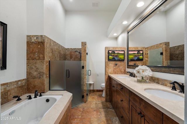 7272 E Gainey Ranch Rd Unit 29, Scottsdale, AZ 85258 - bathroom featuring stone tile flooring, a garden tub, double vanity, toilet, and a shower stall