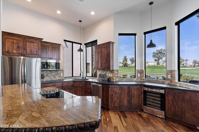7272 E Gainey Ranch Rd Unit 29, Scottsdale, AZ 85258 - kitchen with wine cooler, stainless steel appliances, a sink, plenty of natural light, and recessed lighting