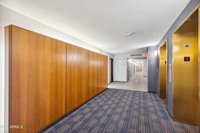 hall featuring dark colored carpet