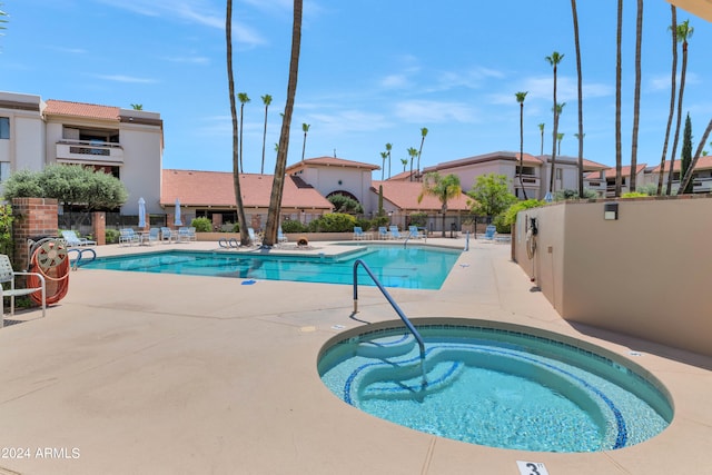 view of pool featuring a patio and a hot tub