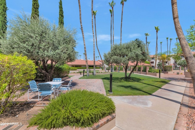 surrounding community featuring a patio and a lawn