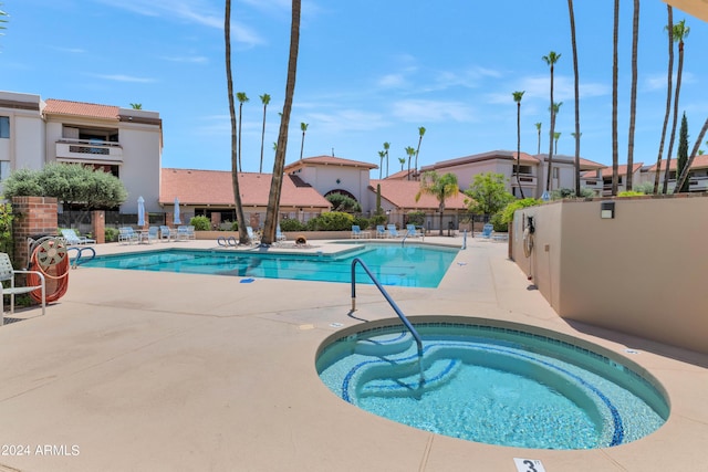17404 N 99th Ave Unit 108, Sun City, AZ 85373 - community pool featuring a hot tub and a patio