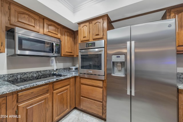 17404 N 99th Ave Unit 108, Sun City, AZ 85373 - kitchen featuring appliances with stainless steel finishes, crown molding, brown cabinetry, and stone countertops