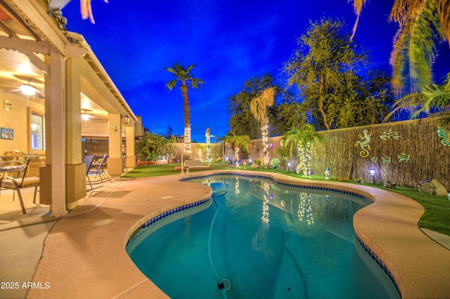 pool at twilight featuring a patio, a fenced in pool, and a fenced backyard