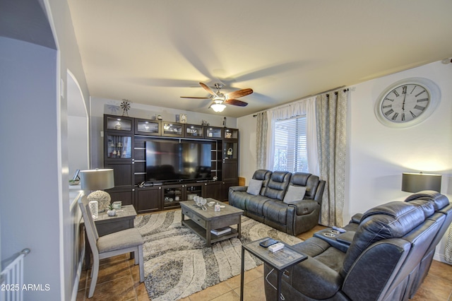 tiled living area with ceiling fan