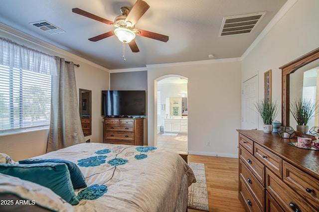 bedroom with ornamental molding, arched walkways, and visible vents