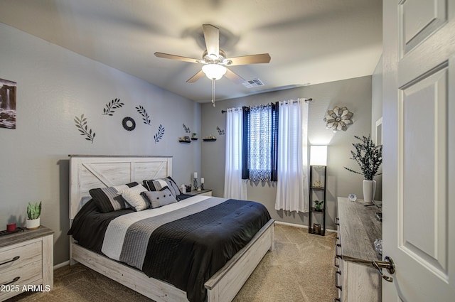 bedroom with baseboards, visible vents, a ceiling fan, and light colored carpet