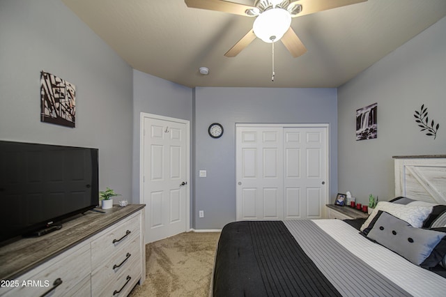 bedroom featuring light colored carpet, a closet, and a ceiling fan