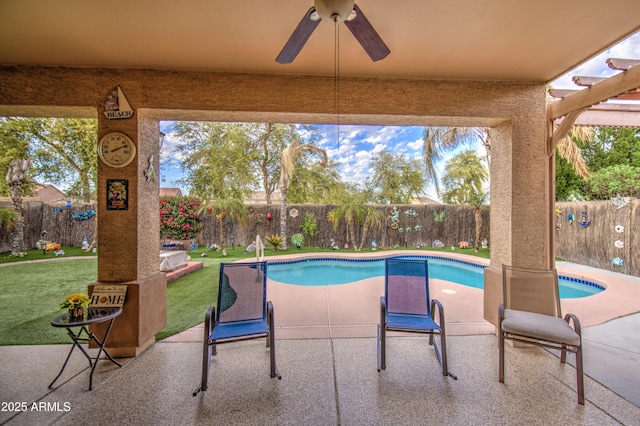 view of swimming pool featuring a fenced backyard, a fenced in pool, a ceiling fan, a yard, and a patio area