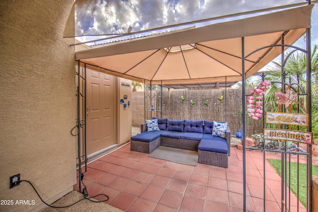 view of patio featuring an outdoor living space and fence