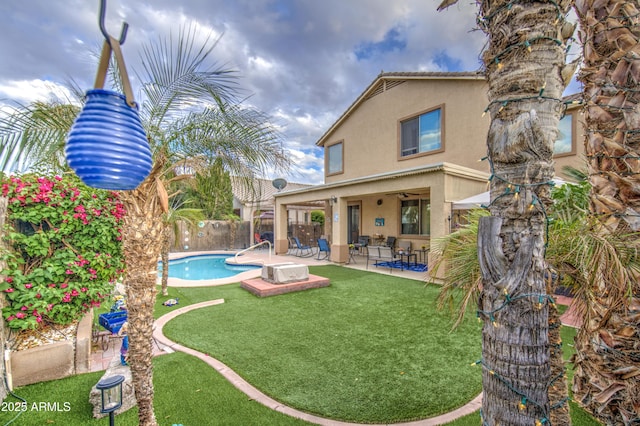 back of house featuring stucco siding, a patio, a fenced backyard, a fenced in pool, and a yard