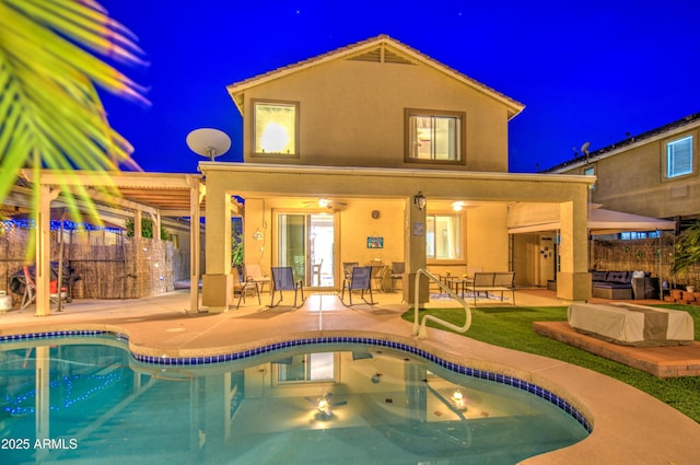 pool at twilight with an outdoor pool, fence, and a patio area